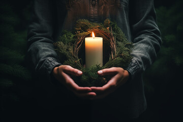 Womens hands holding a christmas candle - obrazy, fototapety, plakaty