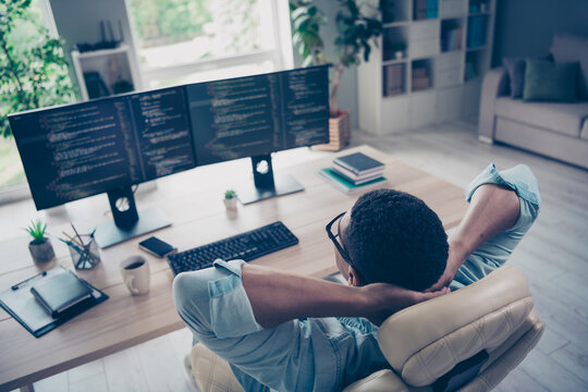 Side view photo of relaxing young funny guy lying comfortable armchair in office while reviewing his website code app indoors workplace