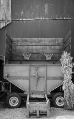 a big truck parked next to a building in black and white
