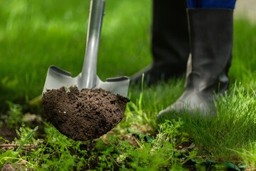 Farmer working in garden digging soil. Farming garden work.