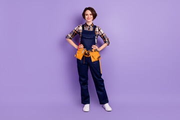 Fototapeta premium Full size photo of young woman happy smile repairer builder tools isolated over violet color background