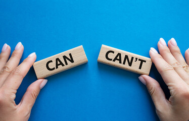 Can or Cant symbol. Concept word Can or Cant on wooden blocks. Businessman hand. Beautiful blue background. Business and Can or Cant concept. Copy space