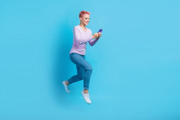 Full body photo of young woman pink hair blogger jump run ordering taxi delivery fast speed web service isolated on blue color background