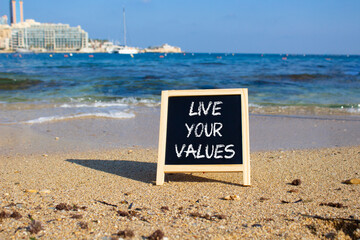 Live your values symbol. Concept words Live your values on chalk blackboard. Beautiful sea...