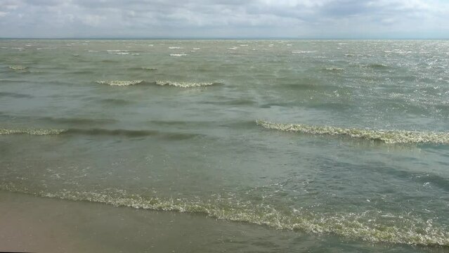 Lagrangian wave. The shore of the hypersalted shallow lake Sivash in storm weather. The Sea of Azov