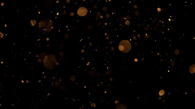4K Multicolored abstract glitter particles. Shimmering Particles Falling glitter with glare on a bokeh background. Titles in awards, music, wedding, anniversary, party, and presentation backdrops.