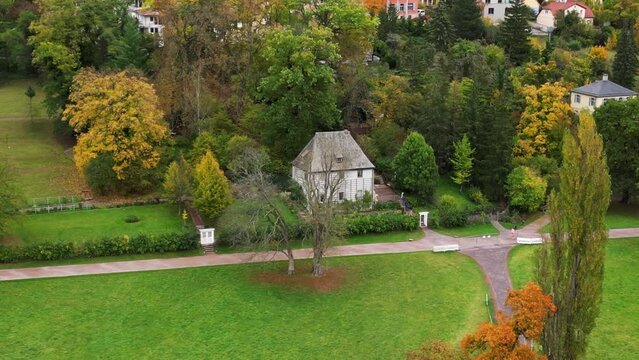 Smooth aerial top view flight drone. Weimar garden house goethe park german fall