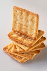 A pile of seven sweet crackers with one standing on top