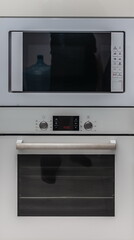 Obraz premium Built-in cabinet microwave and electric oven close-up