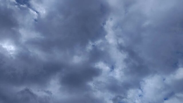 Illuminated sky with clouds of sombre tones circulating through the sky
