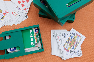 Boxes for cards, playing cards, pens for recording matches. Concept gambling, sports bridge, poker. Sport equipment.