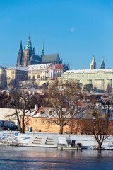 Obraz premium Snowy Prague Lesser Town with Prague Castle above River Vltava in the sunny Day , Czech republic