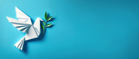 White dove with green olive branch on blue background. Peace symbol banner with copy space. Origami bird