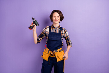 Photo of young attractive woman happy smile repairer hold perforator restoration equipment isolated...