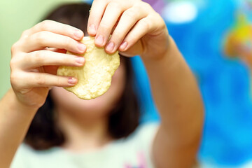 Child's hands holding raw dough