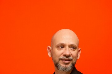 Portrait of a man's head, bald and bearded. 