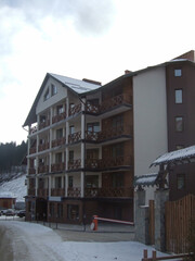 A multi-story hotel with balconies in a ski resort