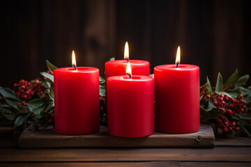 Christmas candles with fir tree branches and berries on dark wooden background.