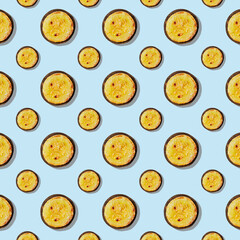 Seamless pattern of grilled zucchini on a wooden round board isolated on blue background.