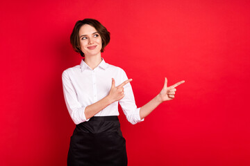 Photo of optimistic nice brunette hair lady point look empty space wear shirt isolated on red color...