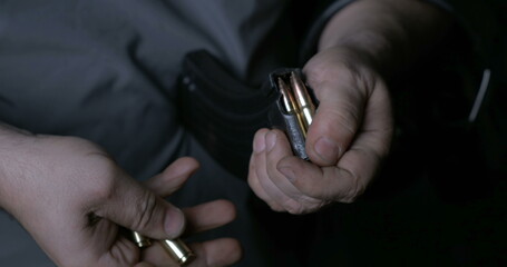 Detailed Hand Action Reloading Bullets into Firearm Clip, Ammunition Preparation Close-Up