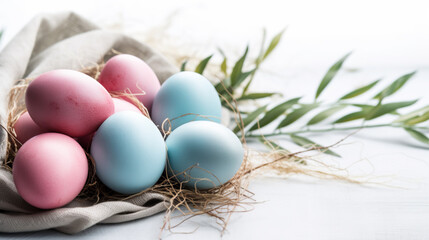 Composition with beautiful pastel colored Easter eggs, spring plant leaves and cloth on grey background