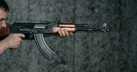 High-Speed 800fps Slow-Motion Shooting with AK-47, Side View of Man Aiming and Firing Kalashnikov...