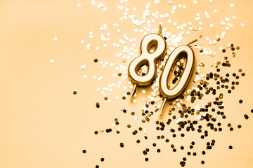 80 years celebration festive background made with golden candles in the form of number Eighty lying...