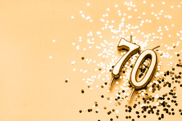70 years celebration festive background made with golden candles in the form of number Seventy...