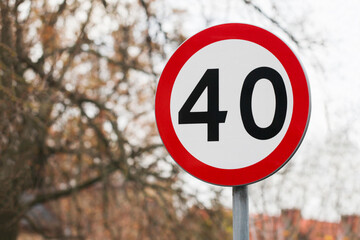 Speed limit road sign. Urban area forty kmph mph. 40 number. Autumn season bad road conditions....