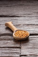 Fenugreek seeds in wooden spoon - healthy food