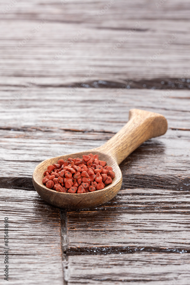 Sticker Bixa Orellana - organic annatto seeds in wooden spoon​