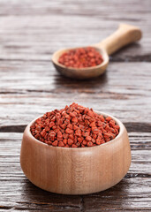 Bixa Orellana - organic annatto seeds in bowl and spoon