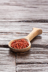 Bixa Orellana - organic annatto seeds in wooden spoon​