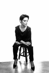 Black and white portrait of an attractive female seated in a chair