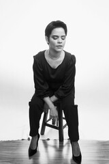 Black and white portrait of an attractive female seated in a chair