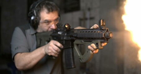 Man aiming and firing an assault rifle in high-speed 800 fps. Shooting with CQR Gun in super...