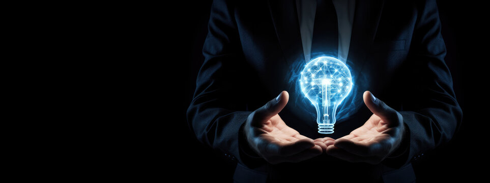 Businessman holding a bluw light bulb in his hand, idea of creativity and innovation concept.