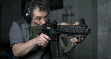 Man aiming and firing an assault rifle in high-speed 800 fps. Shooting with CQR Gun in super...