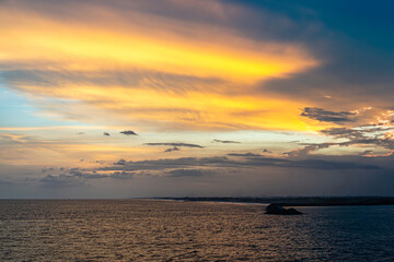 Guatemala, Puerto Quetzal - July 20, 2023: Pacific Ocean shoreline in distance under bright sunset cloudscape