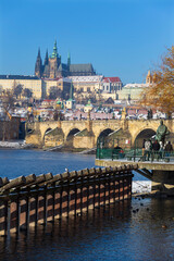 Obraz premium architecture, Czech, gothic, history, medieval, Snowy Prague Lesser Town with Prague Castle and Charles Bridge above River Vltava in the sunny Day , Czech republic