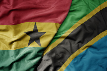big waving national colorful flag of ghana and national flag of tanzania .