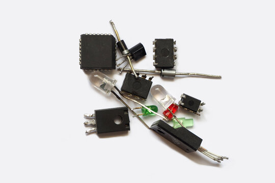 Semiconductor components. Transistors, light emitting diodes and integrated circuits isolated on a grey.
