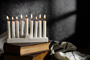 Jewish religious holiday Hanukkah with holiday Hanukkah, dreidel and Taillight on a dark background