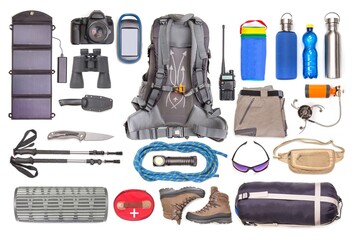 Set of tourist trekking items on white background. Top view of accessories for travel. Equipment...