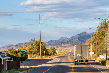 American lorry driving through a small town in the desert along route 15, October 2023 - obrazy, fototapety, plakaty