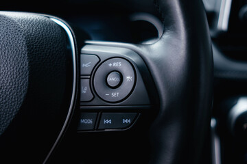 Modern black car interior, leather steering wheel. Details interior. 