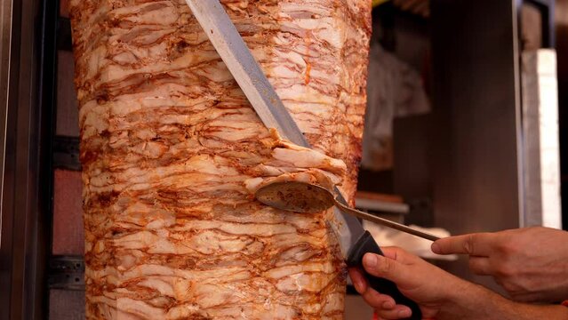 Meat on spit for Shawarma. Grilled meat. Cooking. Chef's Knife Cut Doner Traditional Turkish Meat Doner Kebab. Shawarma or gyroscopes. Greek or Middle Eastern Arabic Style Chicken Doner Kebab Food