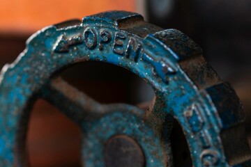 Antique iron valve is depicted with the open direction visible