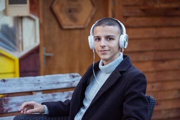 boy with headphones sits and listens to music